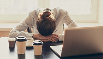 Woman asleep at a desk